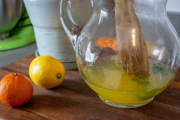 glass pitcher with lemon zest and juice, and orange zest and juice