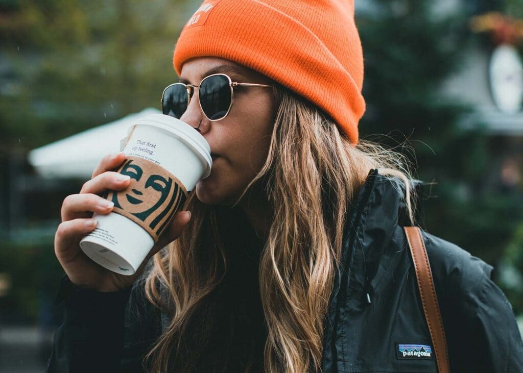 Skinny Vanilla Latte Calories: By Size, Sugar, and Milk Swaps woman drinking coffee