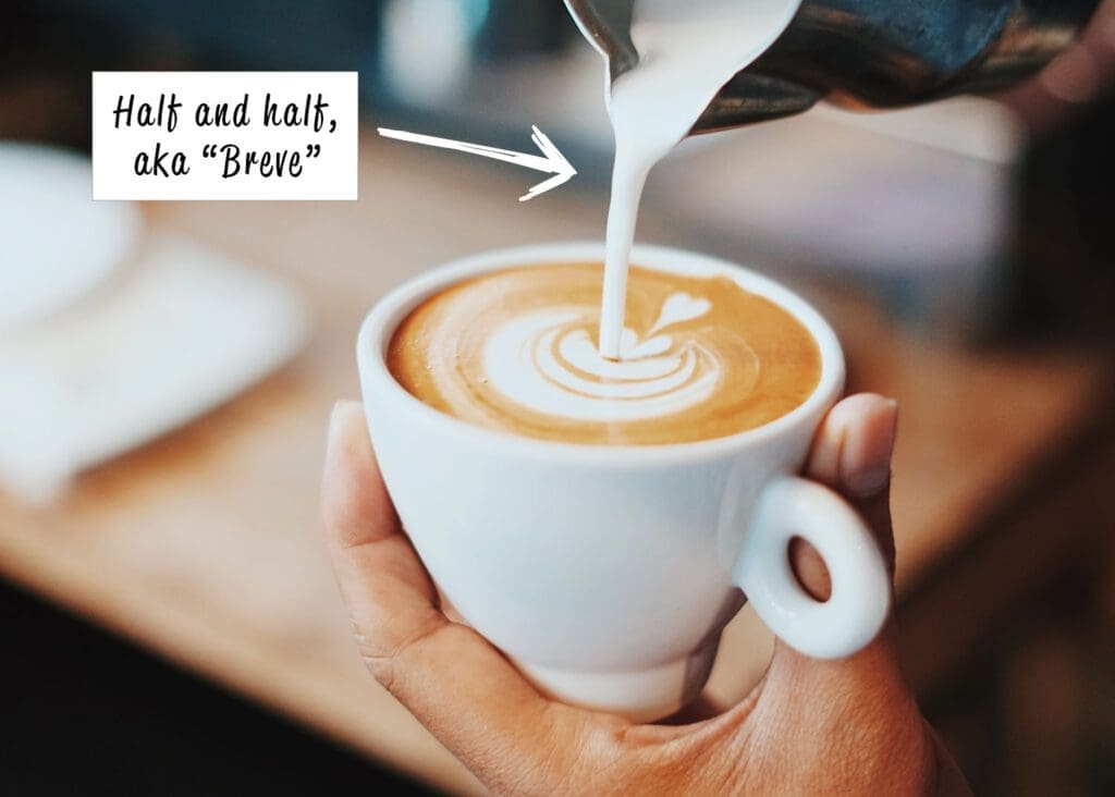 Pouring milk into a coffee cup