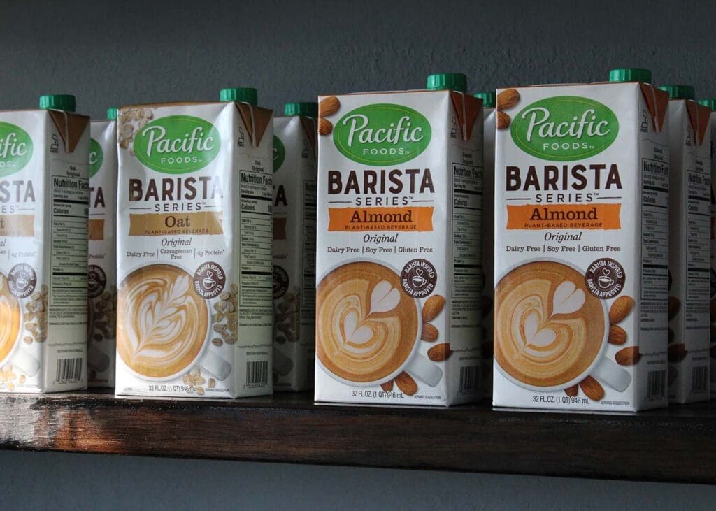 containers of almond milk and oat milk for baristas