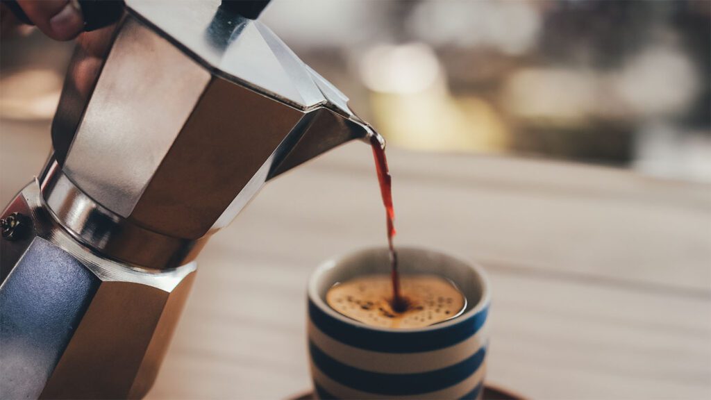 Pouring Rich Espresso From A Moka Pot Into Hot Coffee, Thus Creating A Black Eye