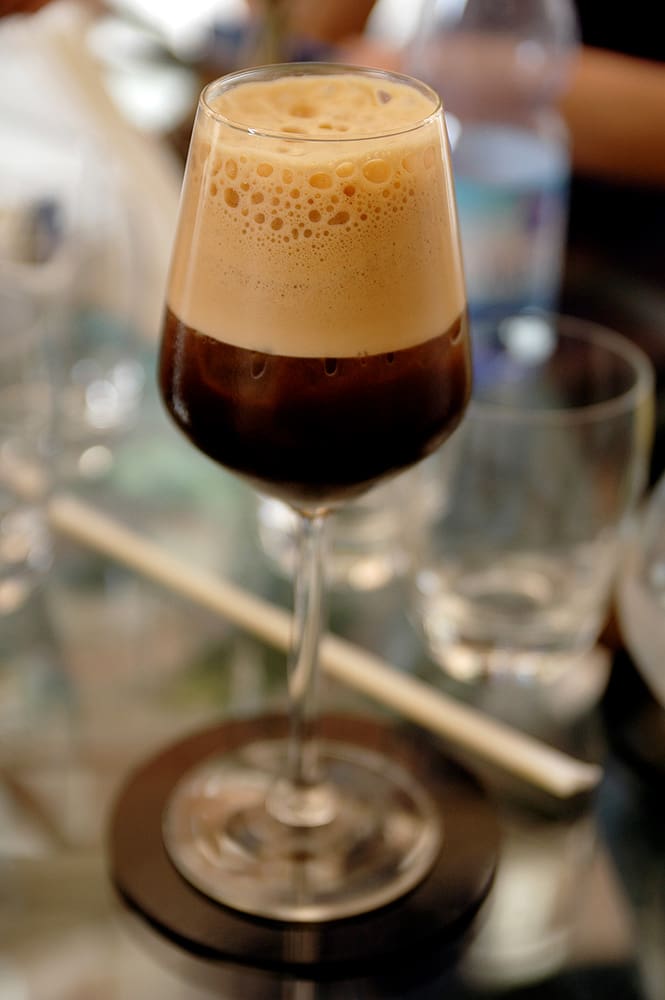 What Is a Caffè Shakerato? A Caffè Shakerato served in a wine glass