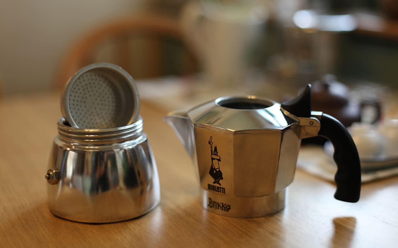 A traditional stovetop Moka pot, disassembled, used for brewing authentic Cuban Cafecito.