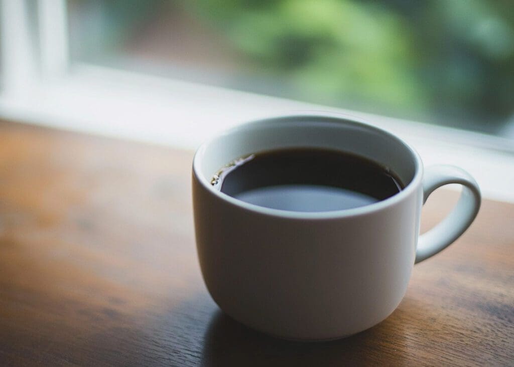a white mug of black coffee