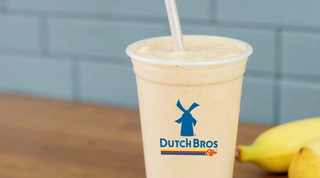 Banana smoothie in a clear cup with Dutch Bros logo