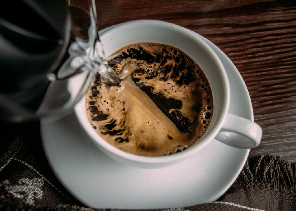 IncredaBrew Coffee - Instant coffee being brewed in a white cup