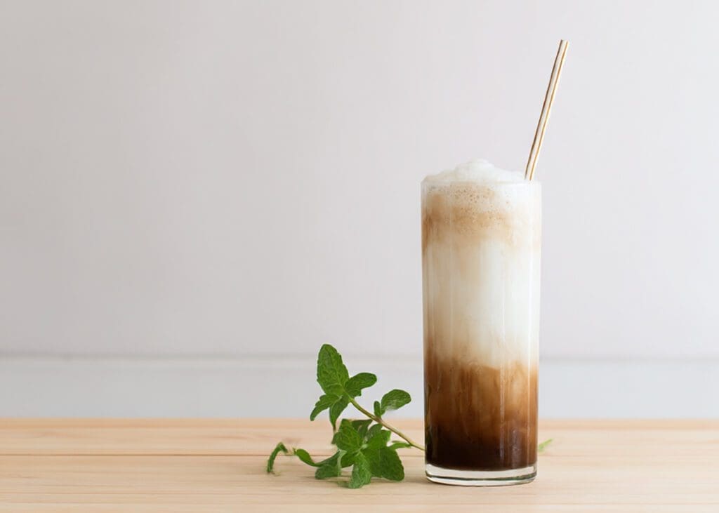 layered frappe in tall glass with foam