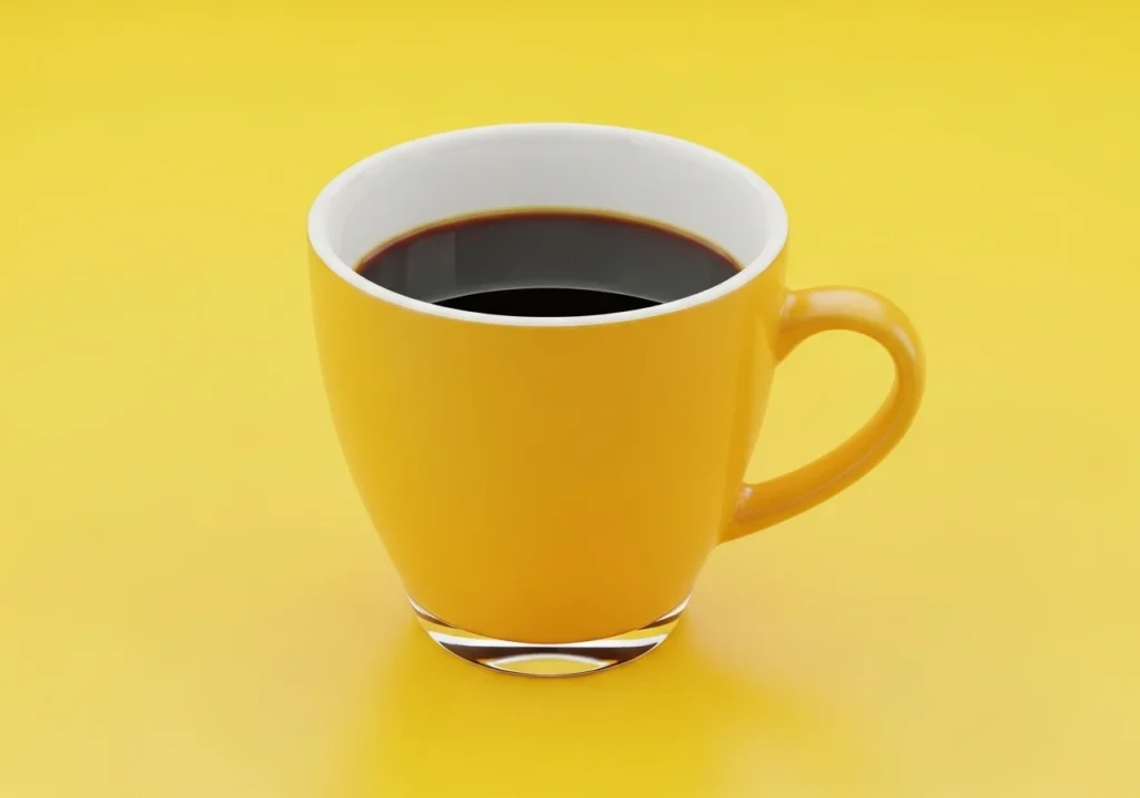 Does Coffee Make Your Pee Yellow? What Your Urine Color Says About Your Health black coffee in a yellow mug on yellow background