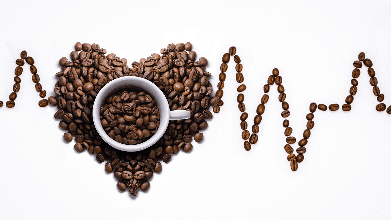 Coffee cup in heart-shaped bean arrangement with EKG-style lines.