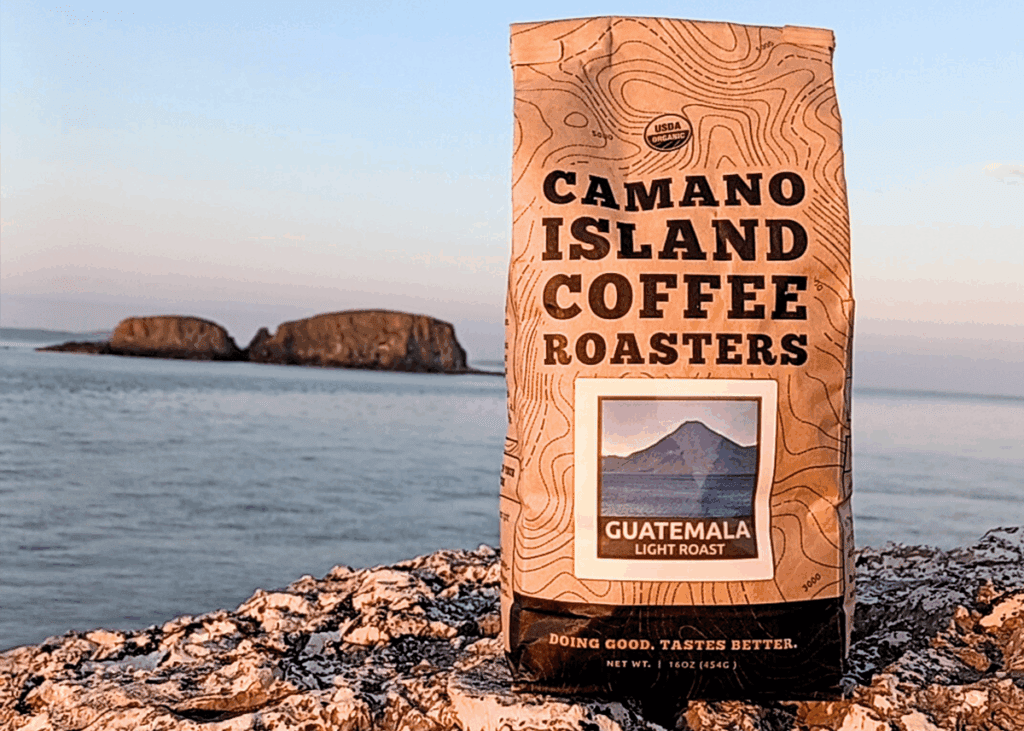 Camano coffee bag by a rocky shoreline