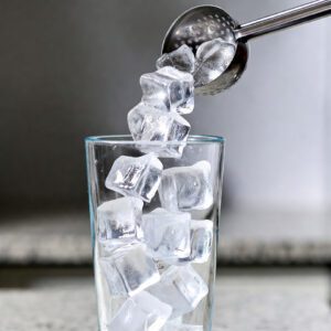Freddo Espresso Recipe — Classic Greek Chilled Espresso With Foam Ice Cubes Falling Into Glass