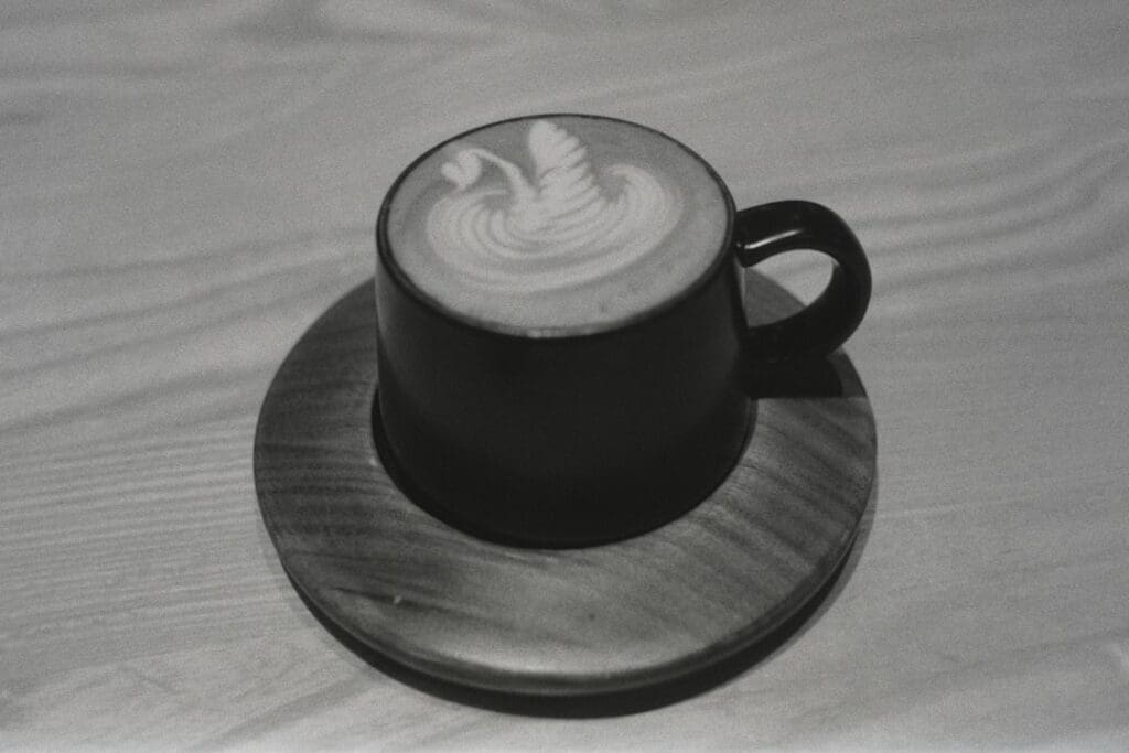 A cappuccino sitting on top of a wooden plate