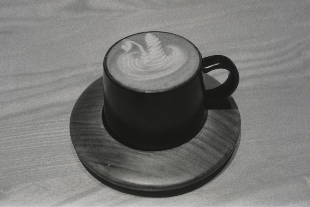 A Cappuccino Sitting On Top Of A Wooden Plate
