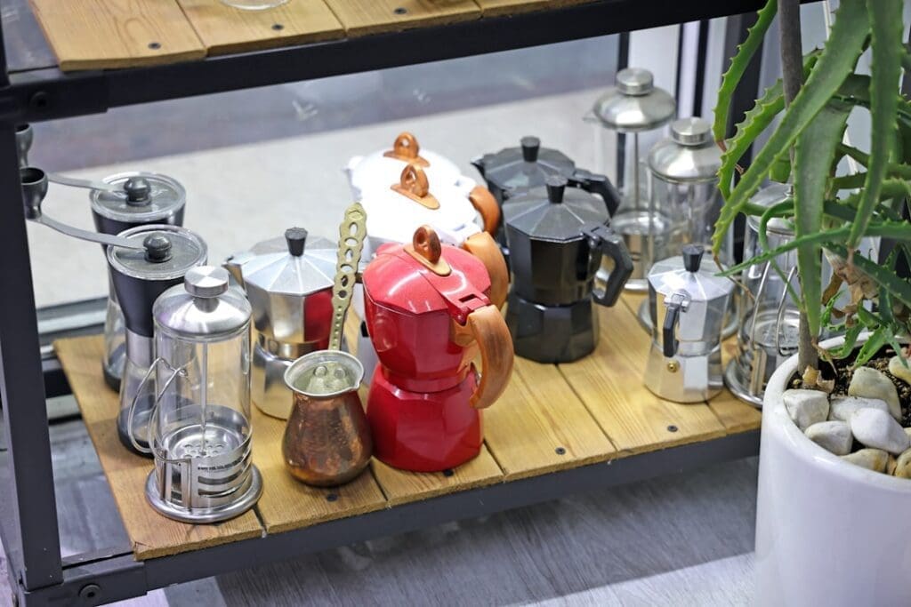 Collection of italian moka pots on a wooden shelf