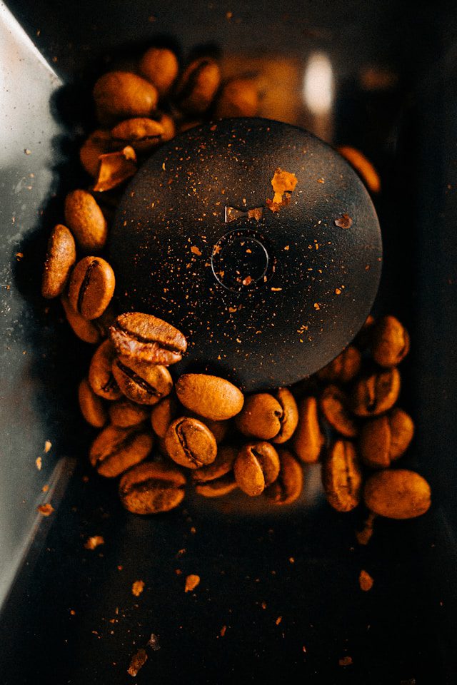 Close-Up Of Coffee Grounds And A Burr Grinder — Morning Brewing