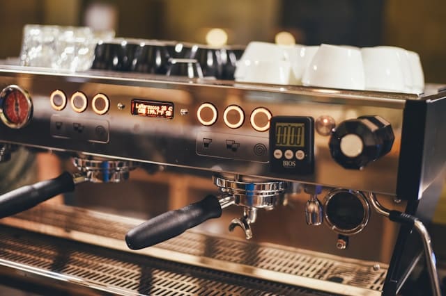 Barista preparing espresso on a commercial coffee machine