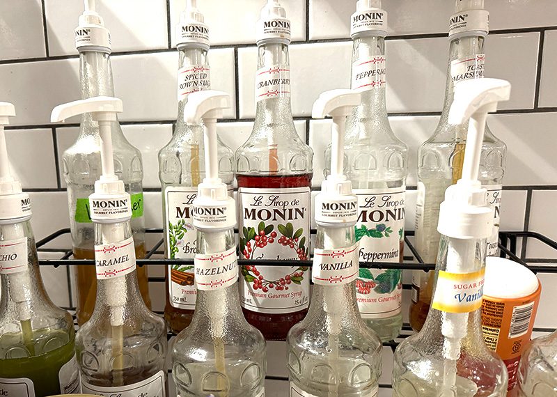 Row Of Monin Syrup Bottles — Flavors For Coffee