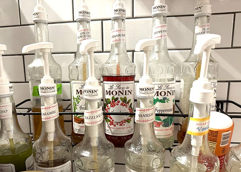 Row of Monin syrup bottles &mdash; flavors for coffee