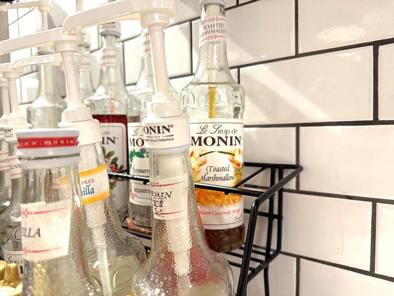 Monin Syrup Being Poured Into A Latte