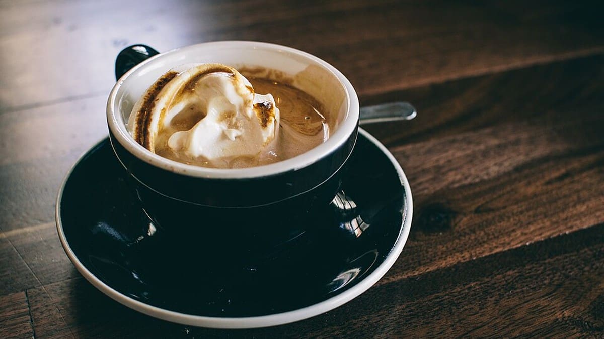 Black coffee in a cup for serving cold drip gently heated