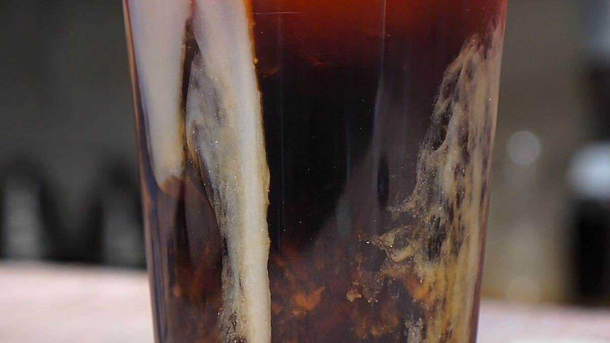 Cold brew coffee with almond milk in a glass
